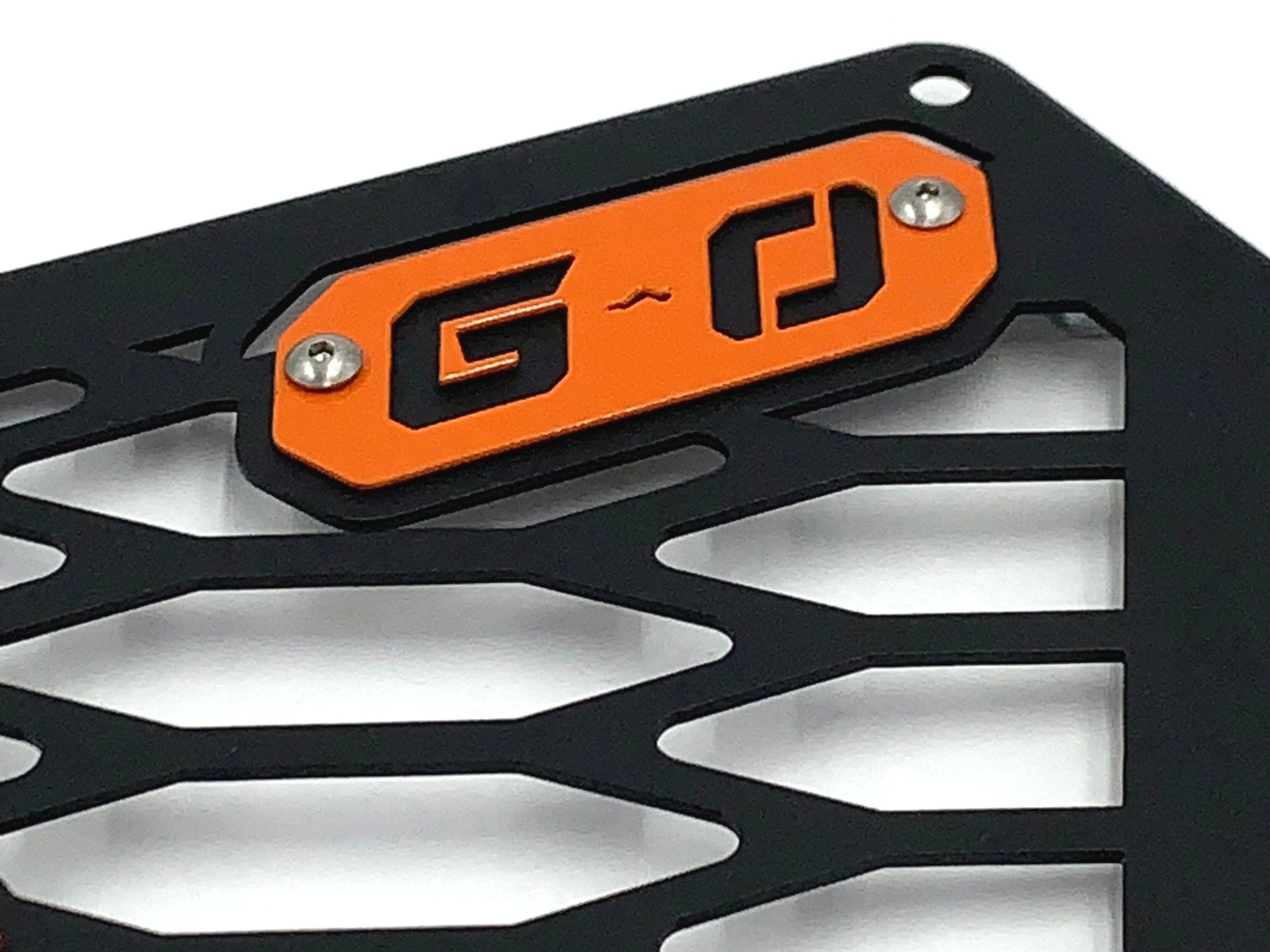 closeup of orange greanland offroad logo on can am grille