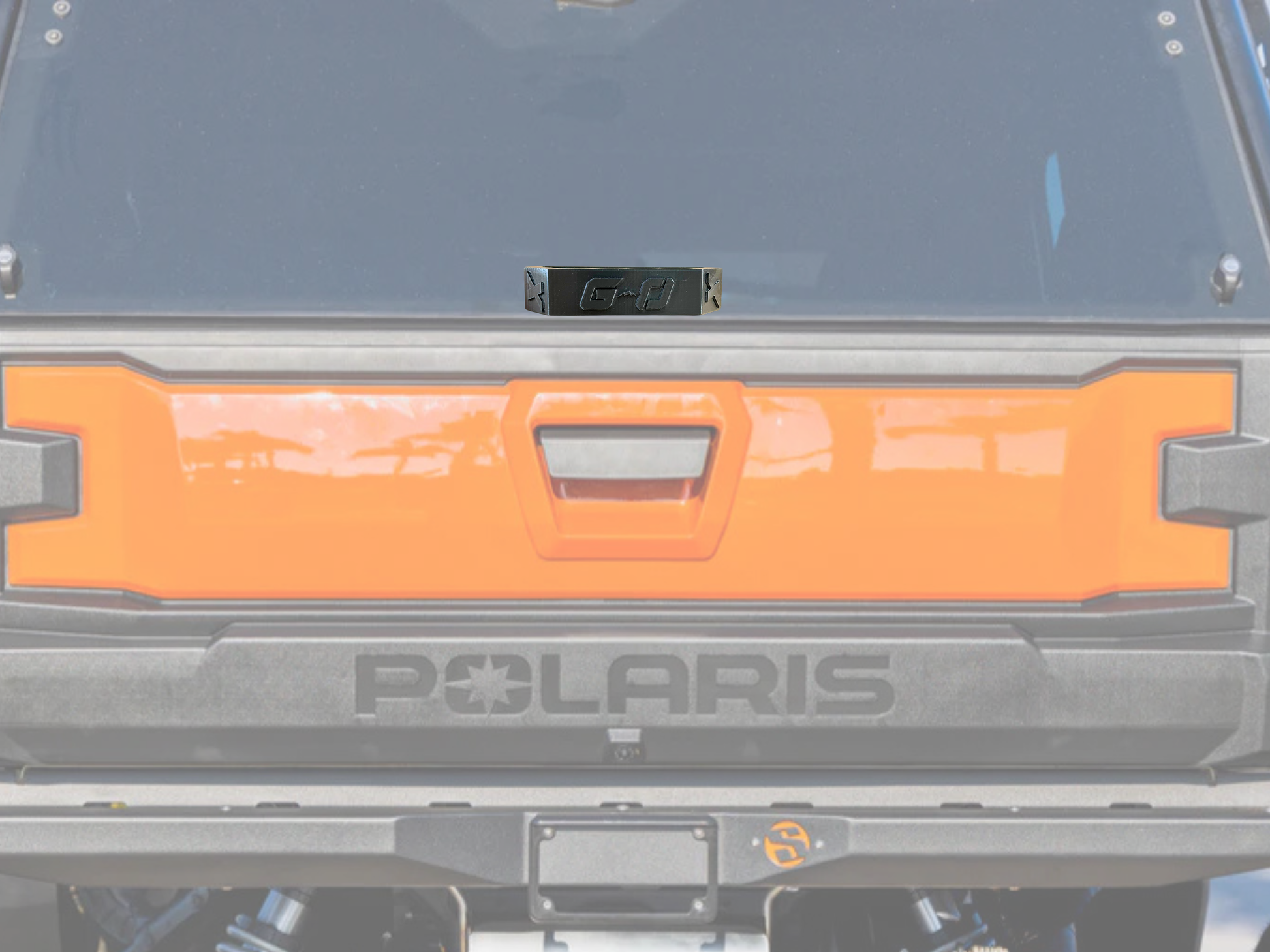Polaris vehicle with an orange license plate holder on a blurred background