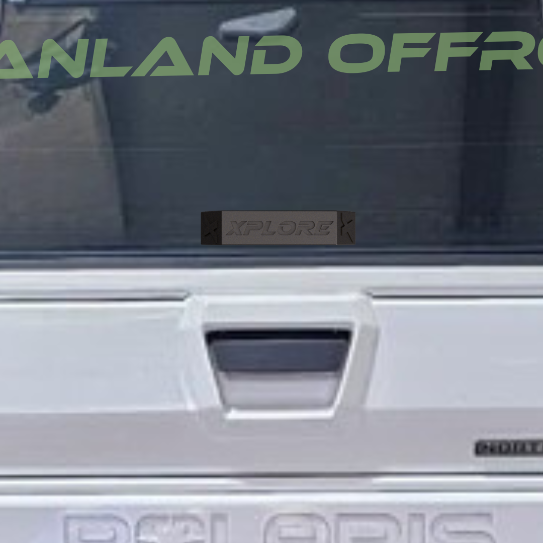 Close-up of a vehicle with 'Polaris' branding and 'Explore' decal on a dark background.